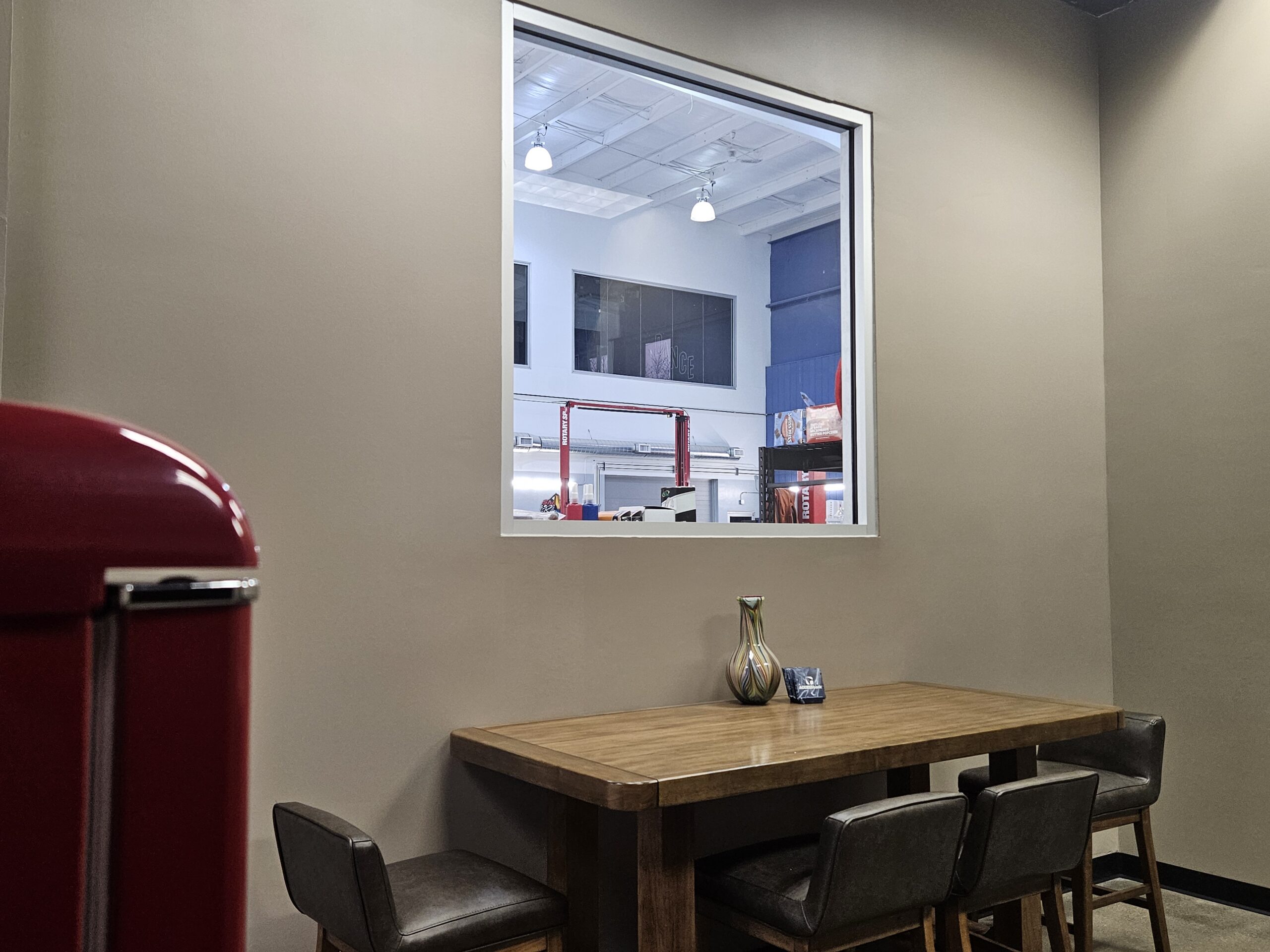 Cafe table overseeing automotive bay at Exclusive Repair West.